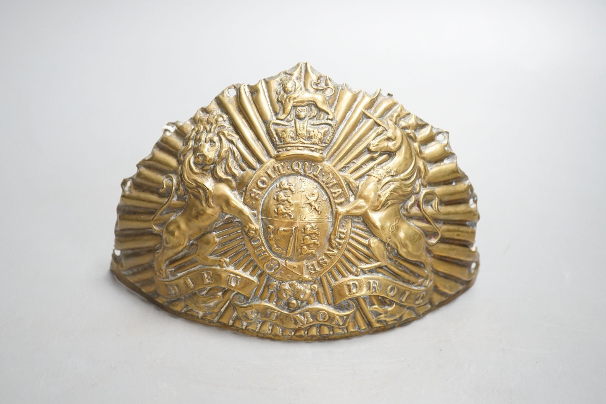 An embossed brass helmet-mount 19cm